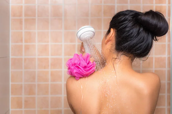 Portrait of beautiful woman taking shower with bath sponge — Stock Photo, Image