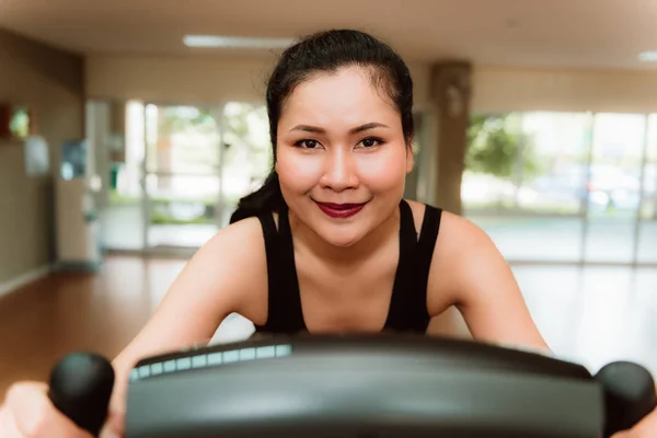 Primer plano retrato de mujer asiática entrenamiento en el ciclismo en la aptitud — Foto de Stock