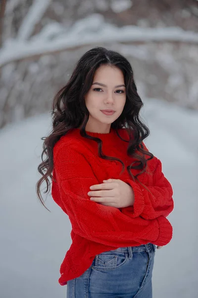 Young beautiful girl wearing red sweater in the winter park.Healthy life and beauty concept. — 스톡 사진