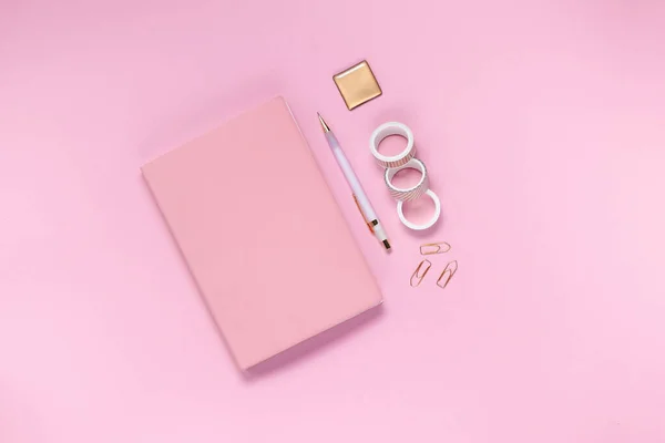 Notepad and notebooks with stationery. Golden, white, pink and black stationery back to school concept. Top horizontal view copyspace — Stock Photo, Image