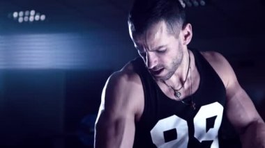 Acımasız adam onun pazı spor salonunda sallıyor.