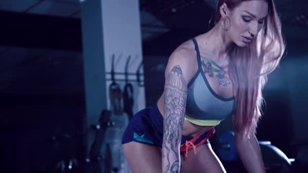 Atletische meisje met tatoeages maken oefening met een barbell — Stockvideo