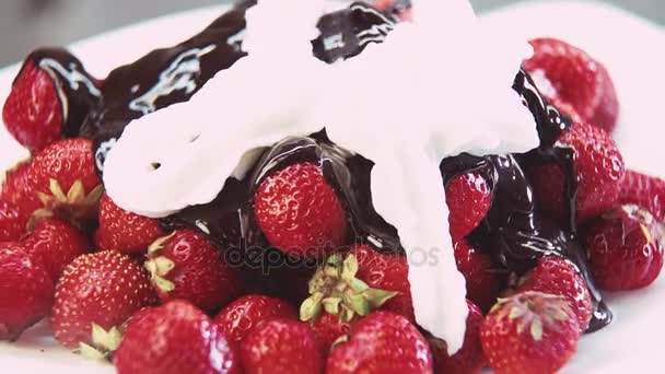 Strawberries in chocolate and whipped cream — Stock Video