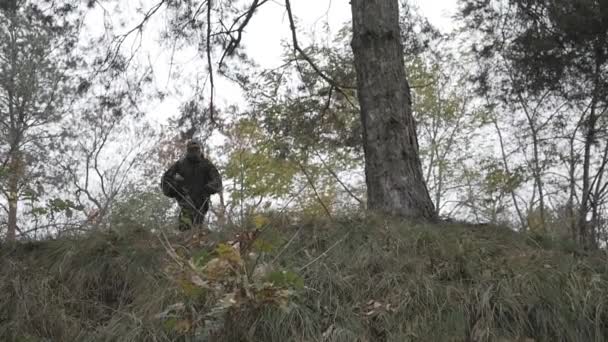 Hombre paintballer haciendo volteretas en el bosque — Vídeos de Stock