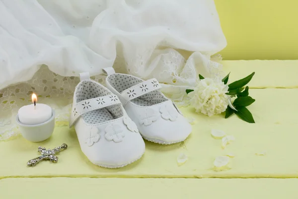 Christening background of vintage lace dress on yellow wood tabl — Stockfoto
