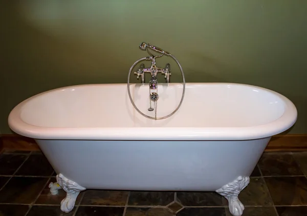 White bath tub against olive green background — Stock Photo, Image