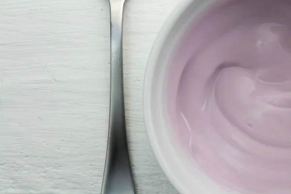 Healthy strawberry fruit flavored yoghurt with natural coloring in a plastic up top view — Stock Photo, Image