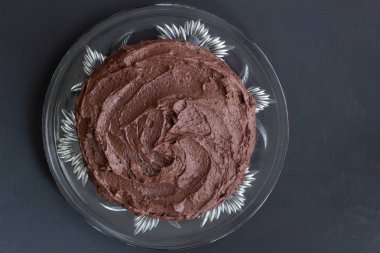 Siyah arka plan üzerine cam tabakta zengin çikolatalı kek Üstten Görünüm