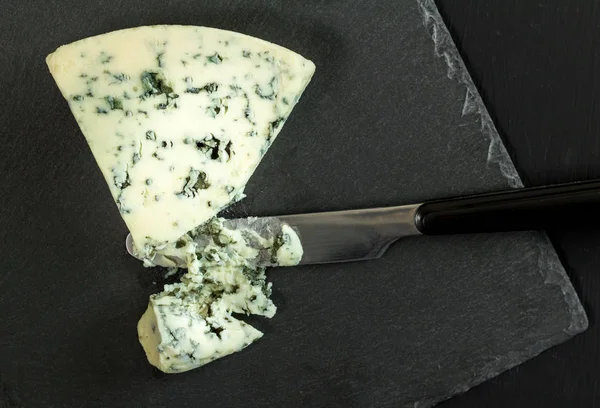 Danish blue cheese on slate board - Top view photo