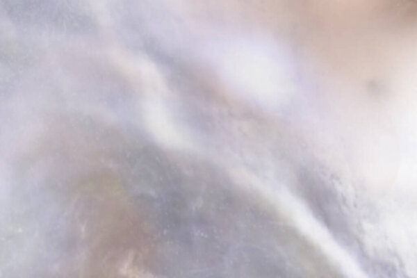 Abstract cloudy blur texture pearl background with shimmering hues of mauve, peach and ocean blue colours