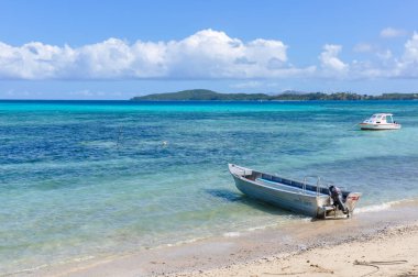 NACULA ISLAND, FIJI - AUGUST 24, 2012: Boat on the beach in Nacula Island in Fiji clipart