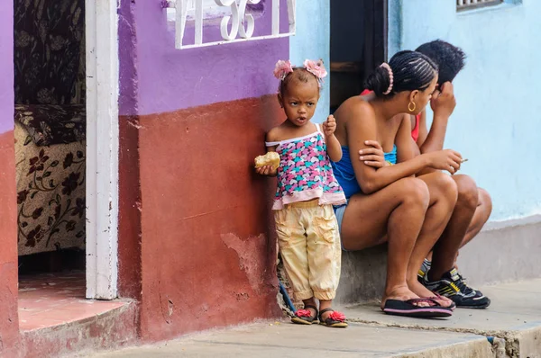 Local kid eating in Trinidad, Cuba Stock Photo