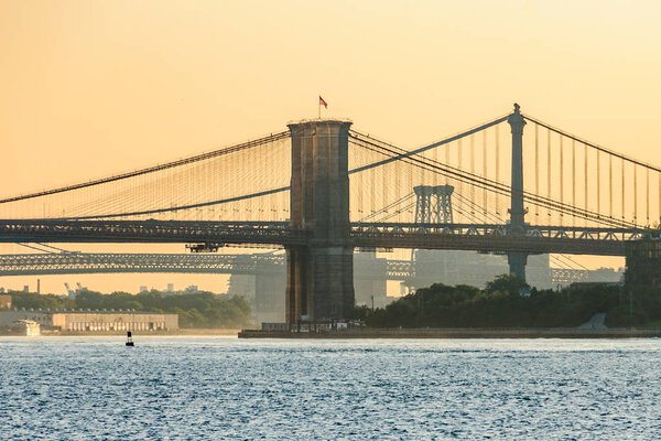 Colors of sunrise over Brooklyn Bridge seen from the Staten Island Ferry, New York, USA