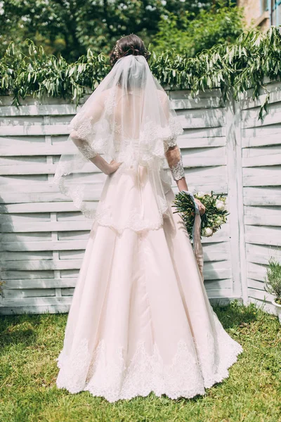 Cream bride dress. Bride in a dress with a bouquet.