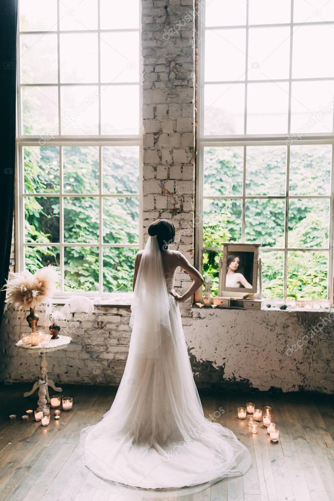 Kind of bride from the back, romantic atmosphere of the bride's morning, Portrait of the bride in the mirror by the window