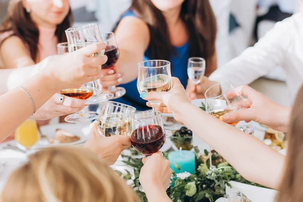 Guests congratulate the newlyweds with a glass of champagne in their hands.