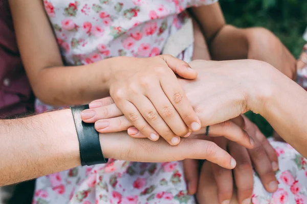 Mom's, daddy's and daughter's hands