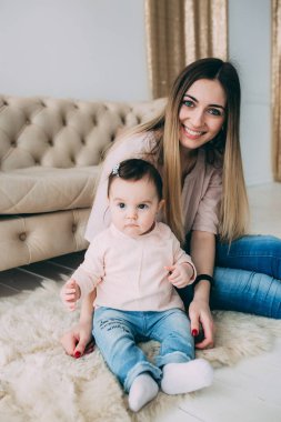 Genç bir annenin kızı rahat bir ev ortamı ile fotoğraf çekimi.