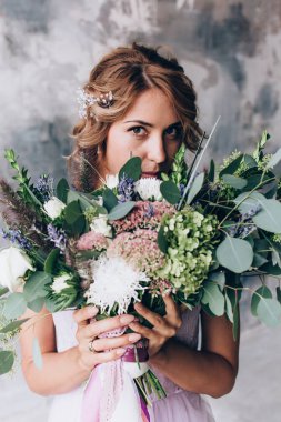 Güzel bir buket ile beyaz gelinlik içinde gelin.