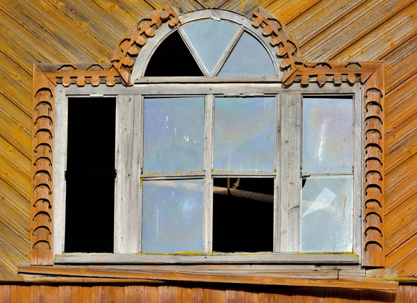 Carved plat bands on windows. Vintage wooden carved window frames on the windows. Decorative, shabby, dusty, window frames — Stock Image Carved Plat Bands Windows Vintage Wooden Carved Window Frames Windows Stock Image