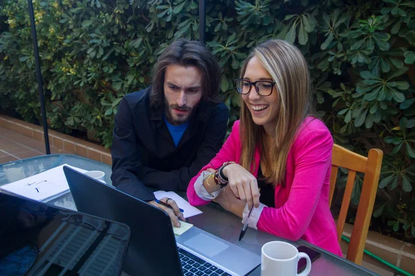 Unga företagare arbetar med laptop på terrassen i deras hus. — Stockfoto