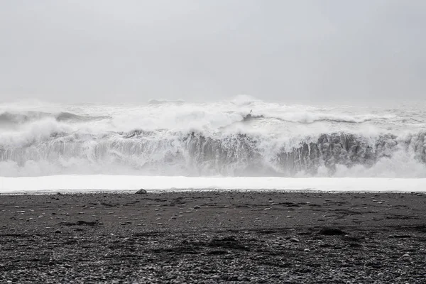 Wellen in schwarzem Sandstrand in Island — Stockfoto