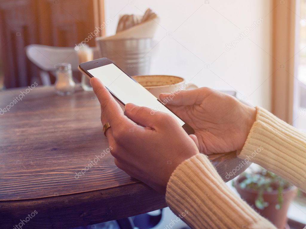 Smartphone isolated from background in the hands of girl in sunn