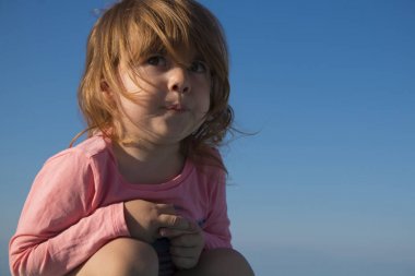 arka plan gökyüzü üzerinde küçük kız gülerek