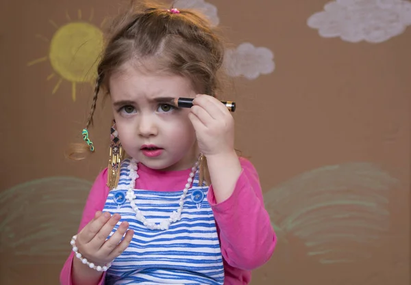 Maquillaje para una niña, labios de color, pestañas y cejas — Foto de Stock