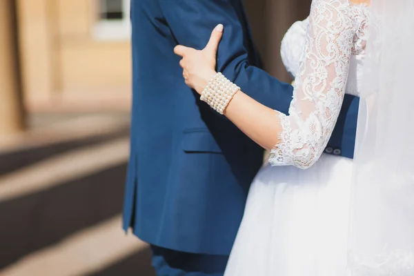 Bruden och brudgummen håller varandras händer. Bröllopsdag — Stockfoto
