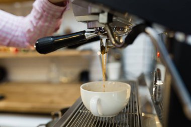 Barista is making coffee in a coffee machine. coffee house