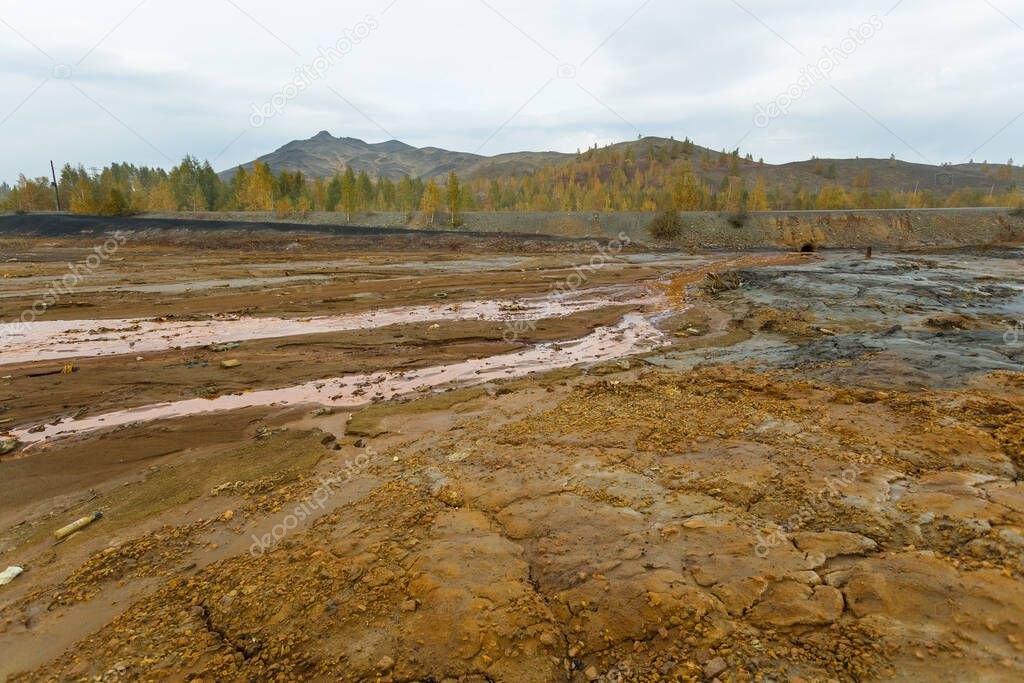 landscape with red soil polluted copper mining factory in Karabash, Russia, Chelyabinsk region
