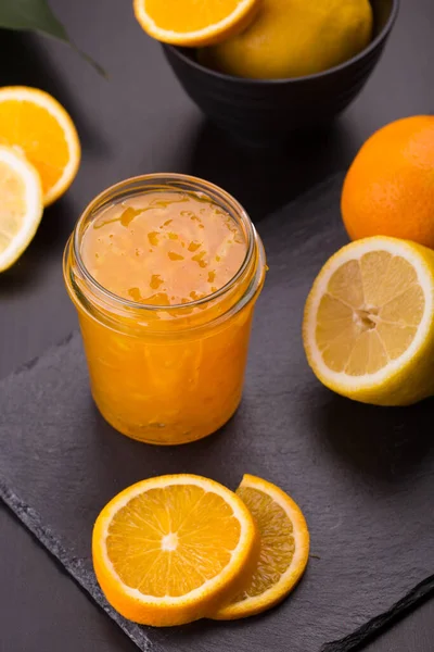 Homemade orange jam in a jar on a black stone background — Stock Photo, Image