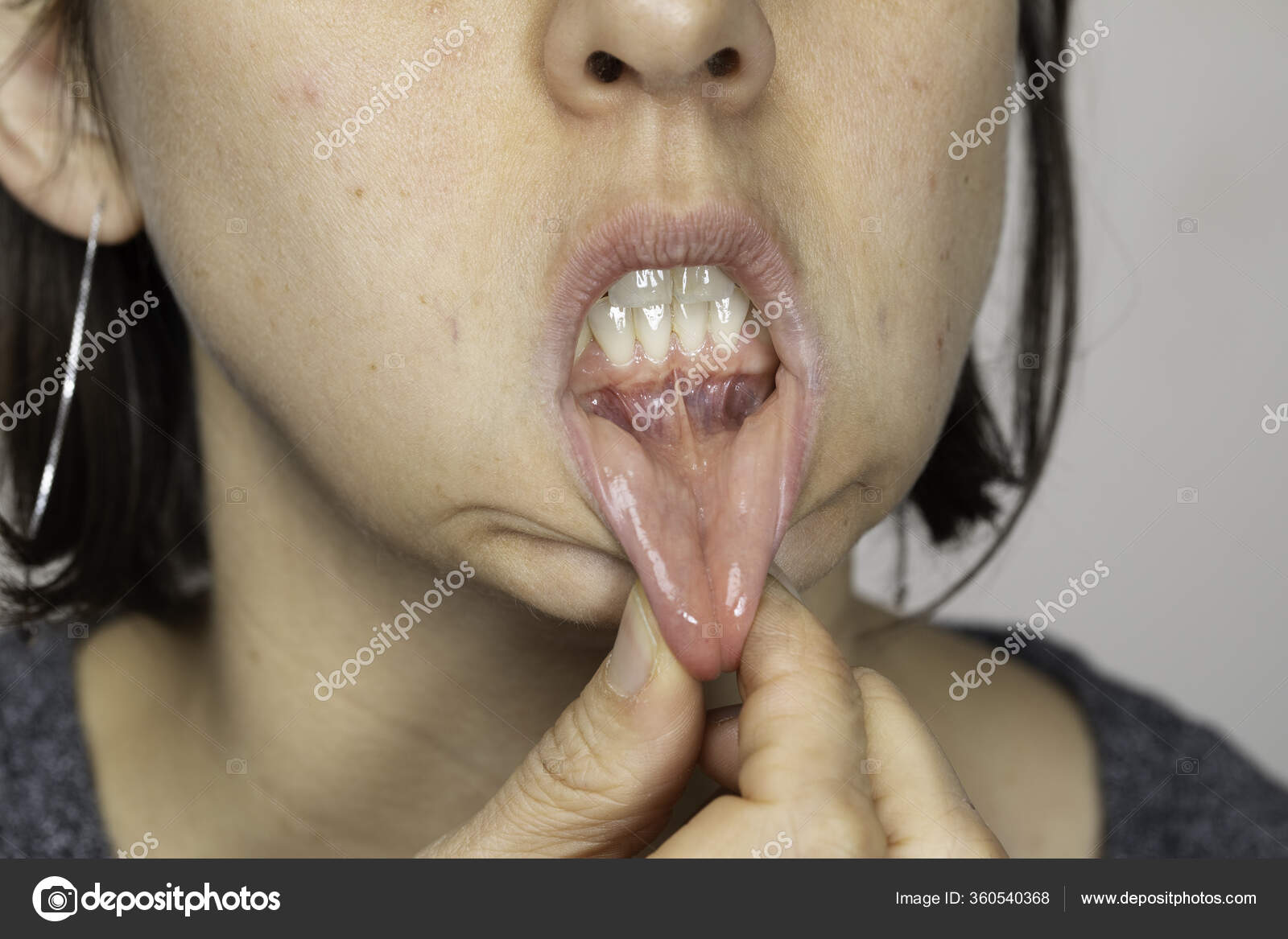 Woman Short Hair Pulling Lower Lip Stock Photo by ©sruilk 360540368