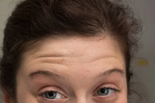 一个皱着眉头的女人的眼睛和额头上的布景 — 图库照片
