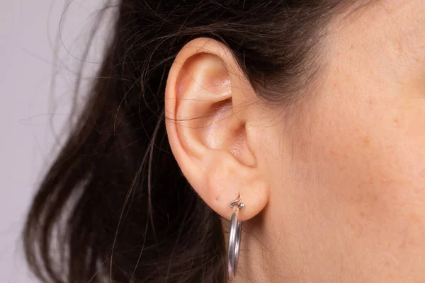 Närbild Kvinnas Öra Trettioårsåldern Hon Har Ett Örhänge Silver Hörselnedsättning — Stockfoto