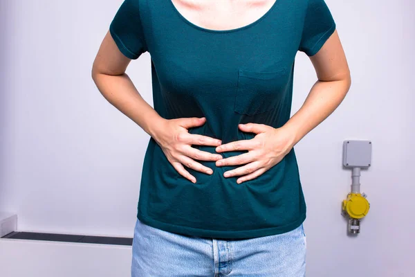 Woman suffering of abdominal pain