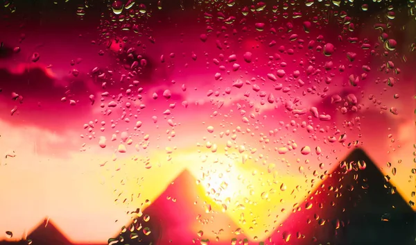 The Egyptian pyramids A view of the city from a window from a high point during a rain. Focus on drops