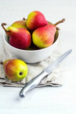 Beyaz bir tabak içinde kırmızı armut bıçak