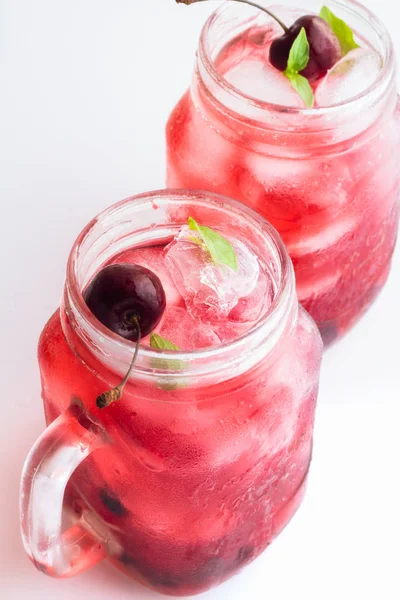 Red drink with ice and cherries — Stock Photo, Image