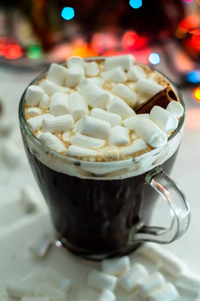 cocoa, coffee with marshmallow on a background of Christmas tree close-up, concept of a new year and christmas