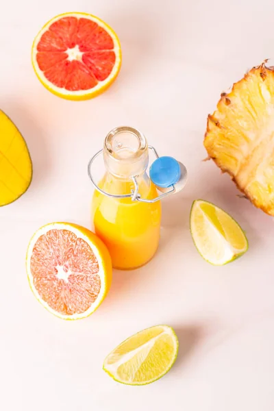 bottle with fruit juice and fruits on a white background top view