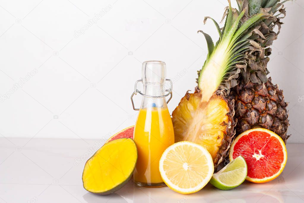 juice and fresh fruits on a white background close-up