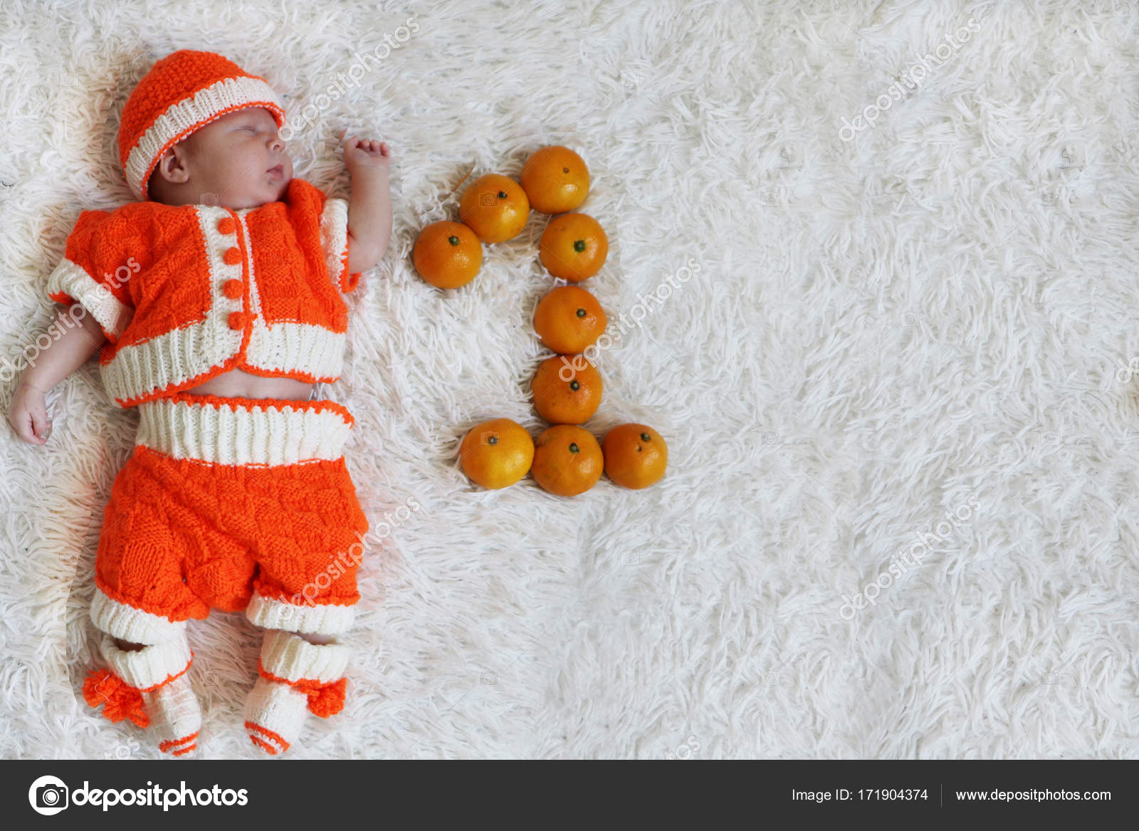 baby in a pumpkin costume