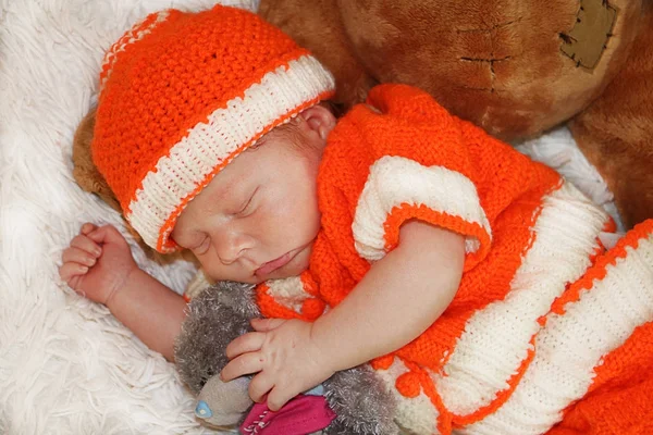 Retrato de lindo bebé recién nacido en traje naranja durmiendo en whit — Foto de Stock