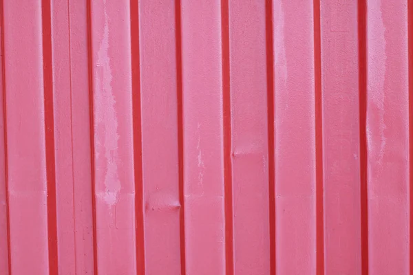 Old, red, crumpled, crimson metal sheet wall fence