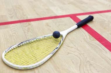 squash racket and ball on the court clipart