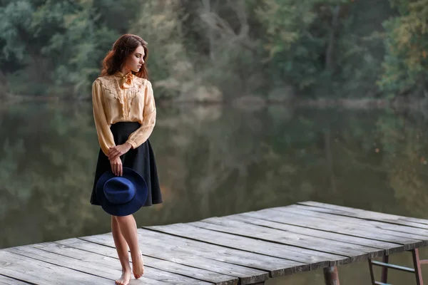 Young woman on wooden bridge — Stock Photo, Image