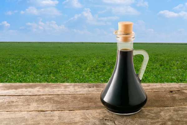Soy sauce in bottle on table — Stock Photo, Image