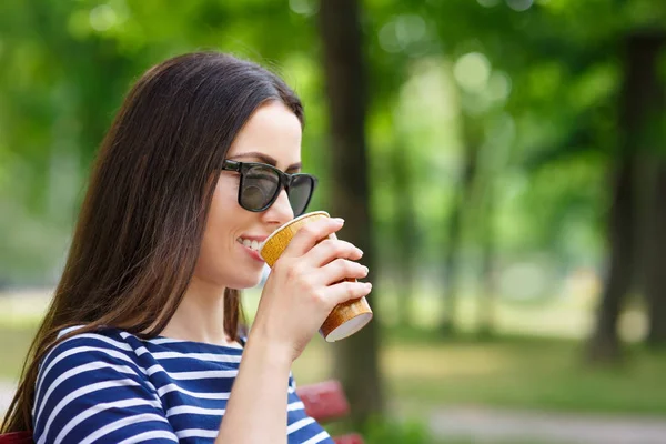 Молода жінка п'є каву на відкритому повітрі — стокове фото
